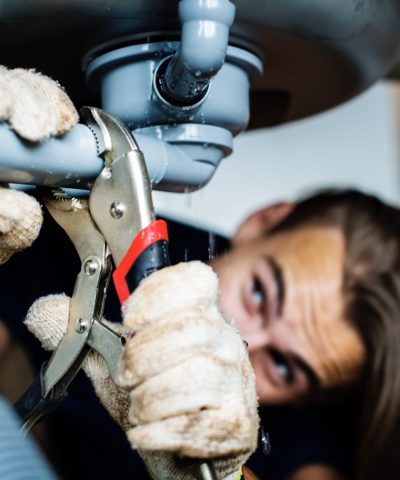 Man fixing kitchen sink